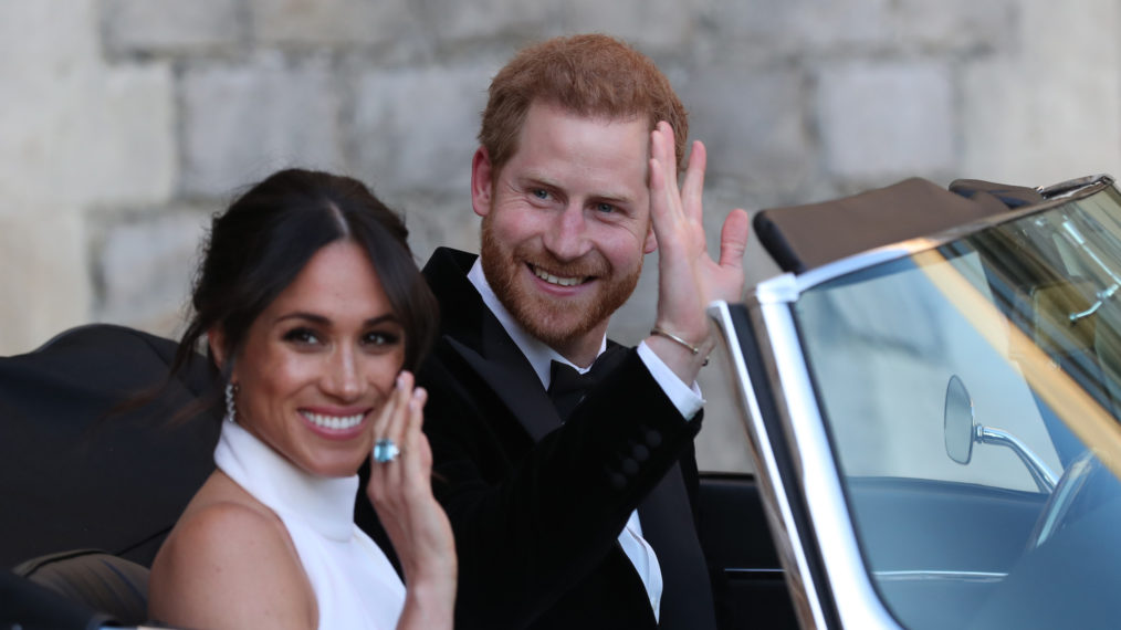 Duchess of Sussex and Prince Harry, Duke of Sussex wave as they leave Windsor Castle after their wedding