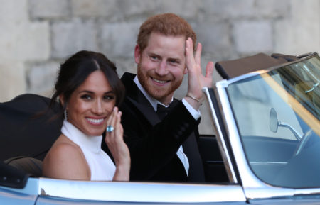 Duchess of Sussex and Prince Harry, Duke of Sussex wave as they leave Windsor Castle after their wedding