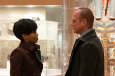 Danielle Moné Truitt as Sergeant Ayanna Bell, Christopher Meloni as Detective Elliot Stabler in the museum in front of a mummy in Law & Order: SVU Organized Crime Crossover
