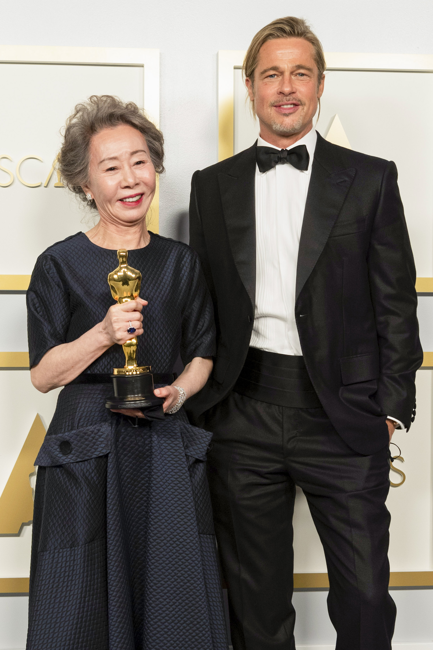 Yuh-Jung Youn poses backstage with the Oscar for Actress in a Supporting Role with Brad Pitt