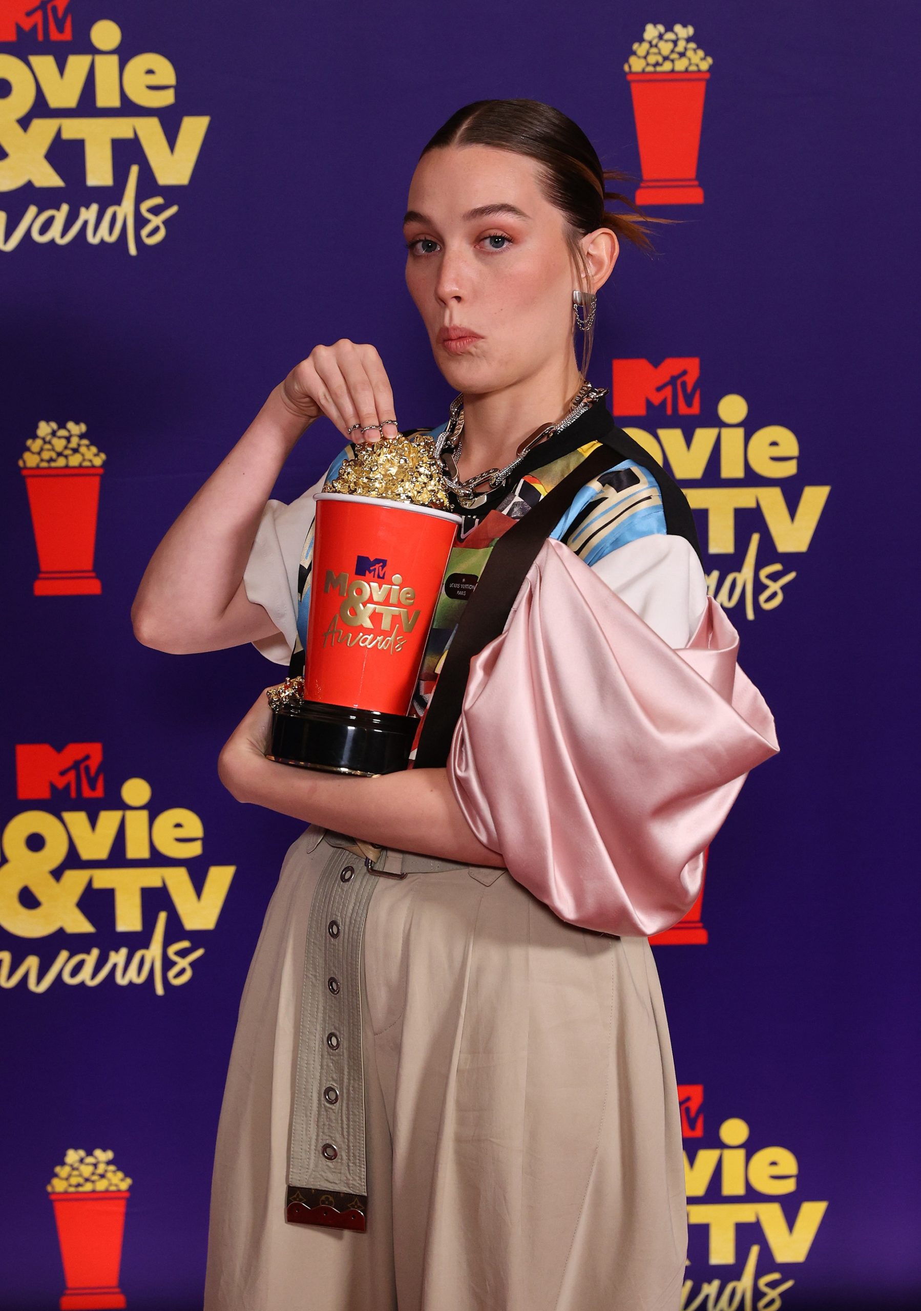 Victoria Pedretti, winner of the Most Frightened Performance award for 'The Haunting of Bly Manor,’ poses with a golden popcorn statuette backstage during the 2021 MTV Movie & TV Awards