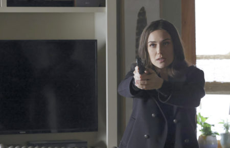 The Blacklist - Megan Boone holding a gun in Season 8