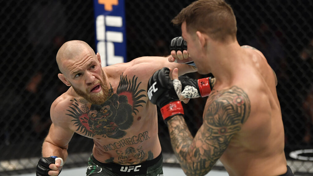 Conor McGregor of Ireland punches Dustin Poirier in a lightweight fight during the UFC 257 event