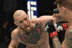 Conor McGregor of Ireland punches Dustin Poirier in a lightweight fight during the UFC 257 event