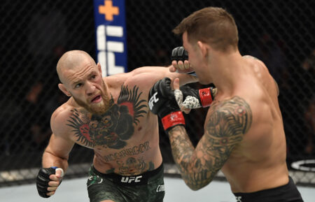 Conor McGregor of Ireland punches Dustin Poirier in a lightweight fight during the UFC 257 event