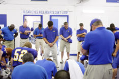 Kyle Chandler as Coach Taylor bowing head in prayer in Friday Night Lights