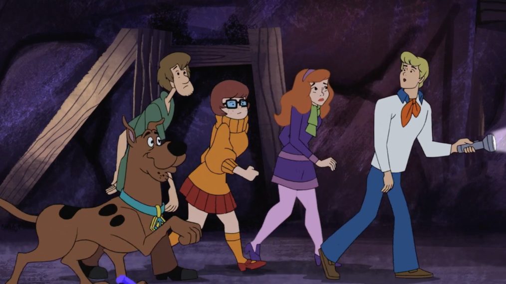 Scooby, Shaggy, Velma, Daphne, and Fred solving a mystery.