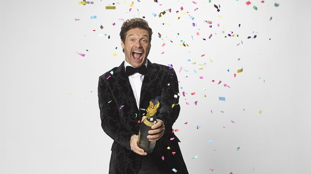 Ryan Seacrest popping a confetti cork