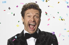Ryan Seacrest popping a confetti cork