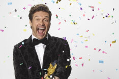 Ryan Seacrest popping a confetti cork