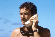 Tom Selleck on the phone on the beach