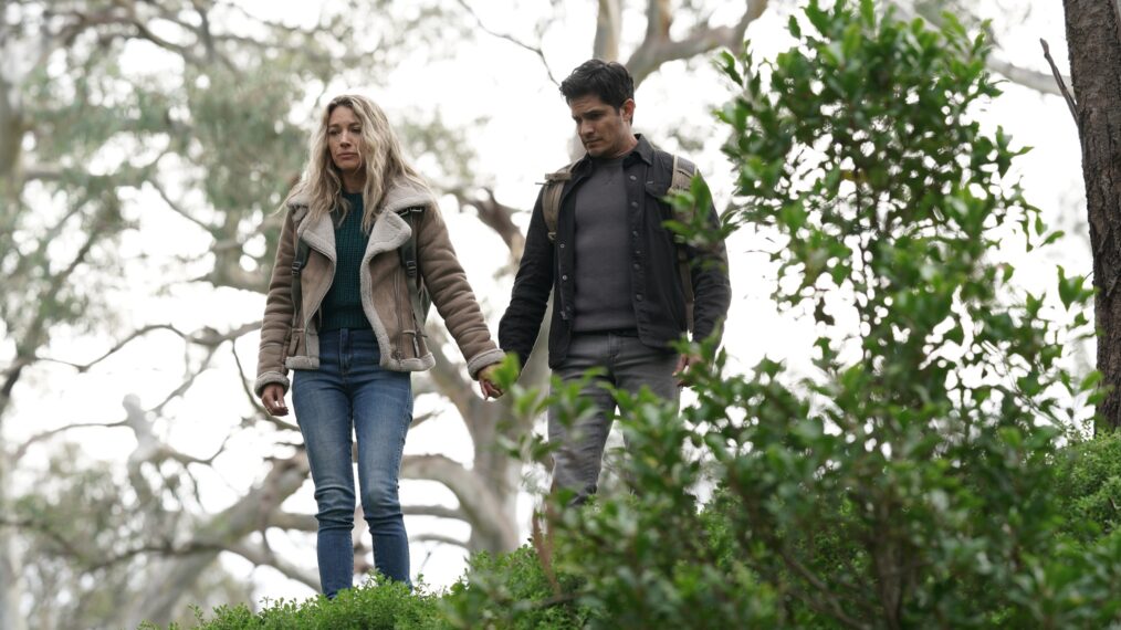 Natalie Zea as Eve Harris and Nicholas Gonzalez as Levi Delgado holding hands in La Brea - Season 2