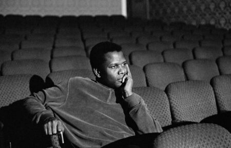 A black-and-white image of Sidney Poitier sitting in a movie theater in the Apple TV+ documentary film 'Sidney'