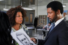 Lorraine Toussaint as Viola 'Vi' Marsette and Tory Kittles as Detective Marcus Dante looking at a police sketch in The Equalizer