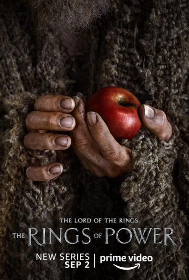 Daniel Weyman holding an apple as the Stranger in The Lord of the Rings: The Rings of Power