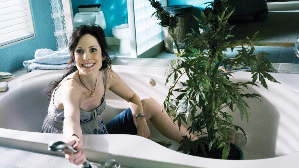 Mary-Louise Parker as Nancy Botwin in a bathtub with a marijuana plant in Weeds