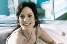 Mary-Louise Parker as Nancy Botwin in a bathtub with a marijuana plant in Weeds
