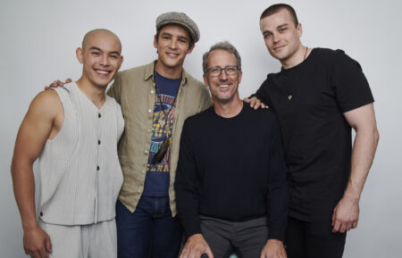 Ryan Potter, Brenton Thwaites, and Joshua Orpin pose with executive producer Greg Walker for a group 'Titans' team portrait at New York Comic Con 2022
