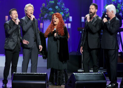 NASHVILLE, TENNESSEE - OCTOBER 30: (L-R) Wes Hampton, Reggie Smith, Wynonna Judd, Adam Crabb and Larry Strickland perform onstage for CMT Coal Miner's Daughter: A Celebration of the Life & Music of Loretta Lynn at Grand Ole Opry on October 30, 2022 in Nashville, Tennessee. (Photo by Terry Wyatt/Getty Images for CMT)