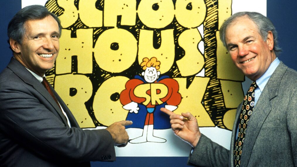 George Newall in front of 'Schoolhouse Rock' poster.