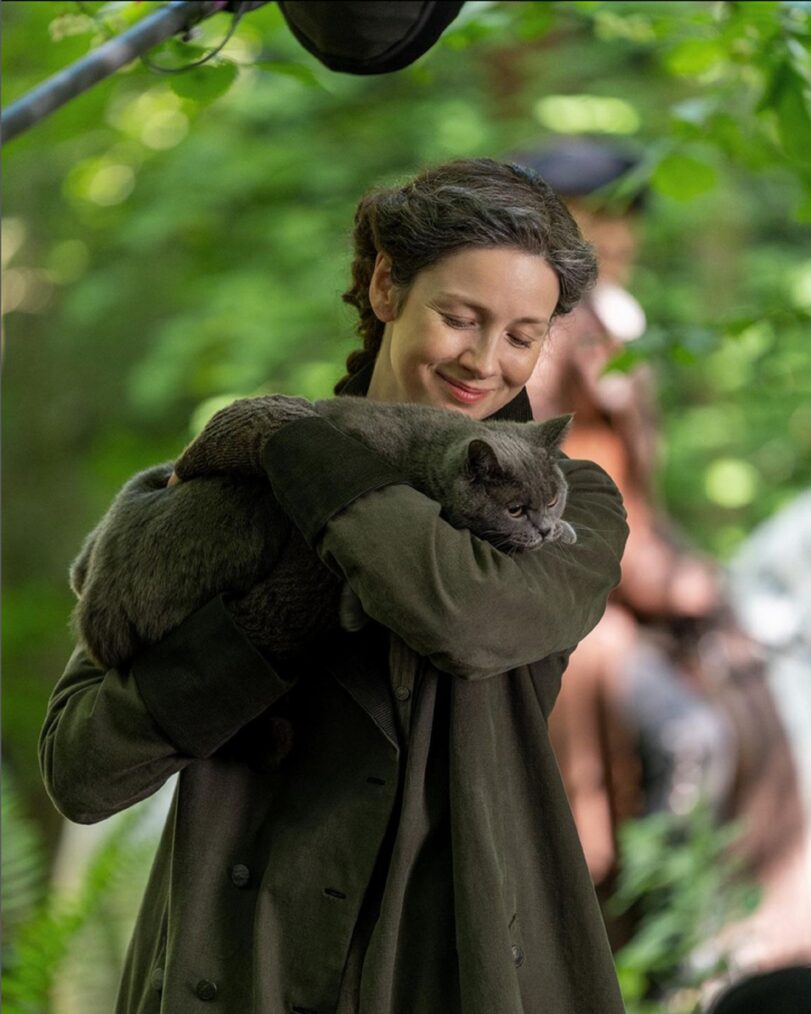 Caitriona Balfe with a cat behind the scenes of 'Outlander' Season 7