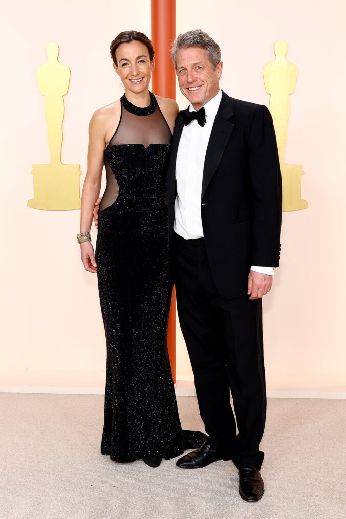Anna Eberstein and Hugh Grant arrive at the 2023 Oscars