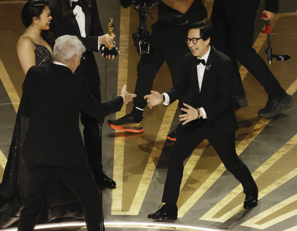 Ke Huy Quan accepts the award for Best Picture from Harrison Ford at the 2023 Oscars