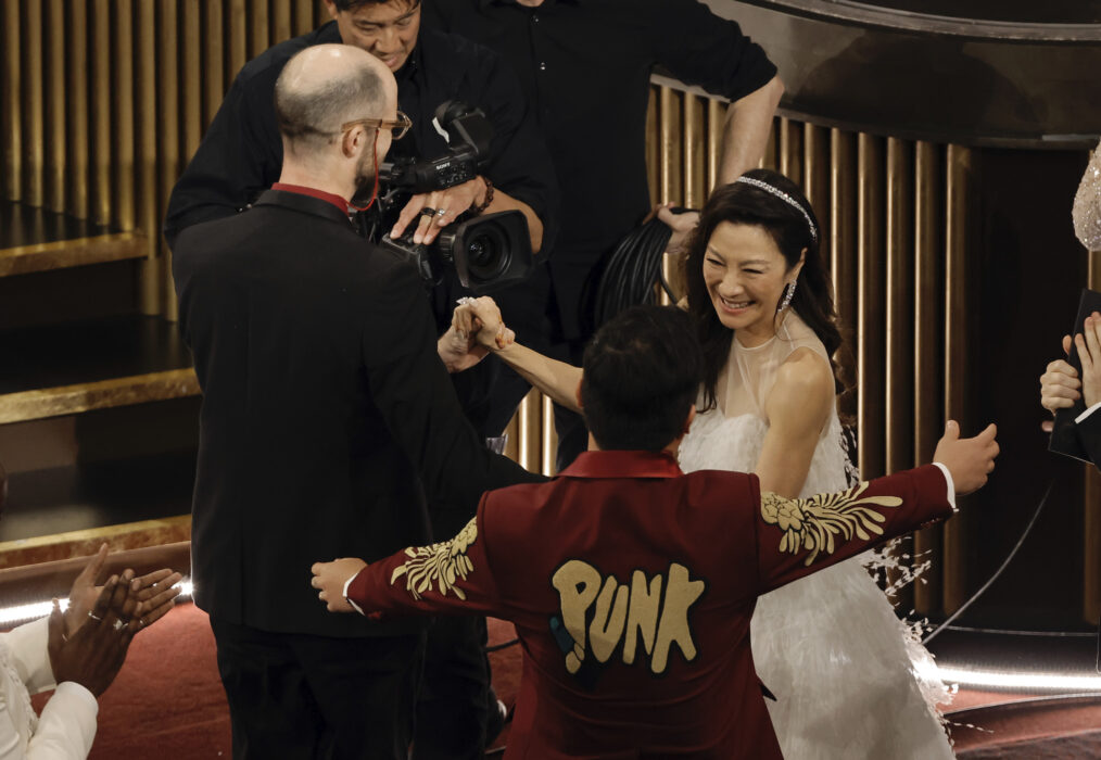 Daniel Scheinert and Daniel Kwan celebrate with Michelle Yeoh while accepting the Best Director award for 'Everything Everywhere All at Once' during the 2023 Oscars