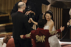 Daniel Scheinert and Daniel Kwan celebrate with Michelle Yeoh while accepting the Best Director award for 'Everything Everywhere All at Once' during the 2023 Oscars