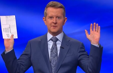 Ken Jennings holds up clue card
