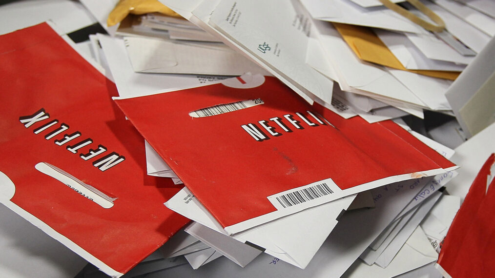 Red Netflix DVD envelopes sit in a bin of mail at the U.S. Post Office sort center