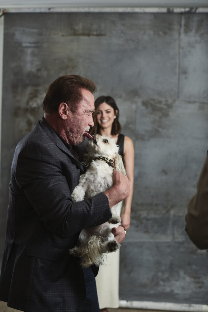 Monica Barbaro and Arnold Schwarzenegger, with Augie, behind the scenes of 'FUBAR' shoot