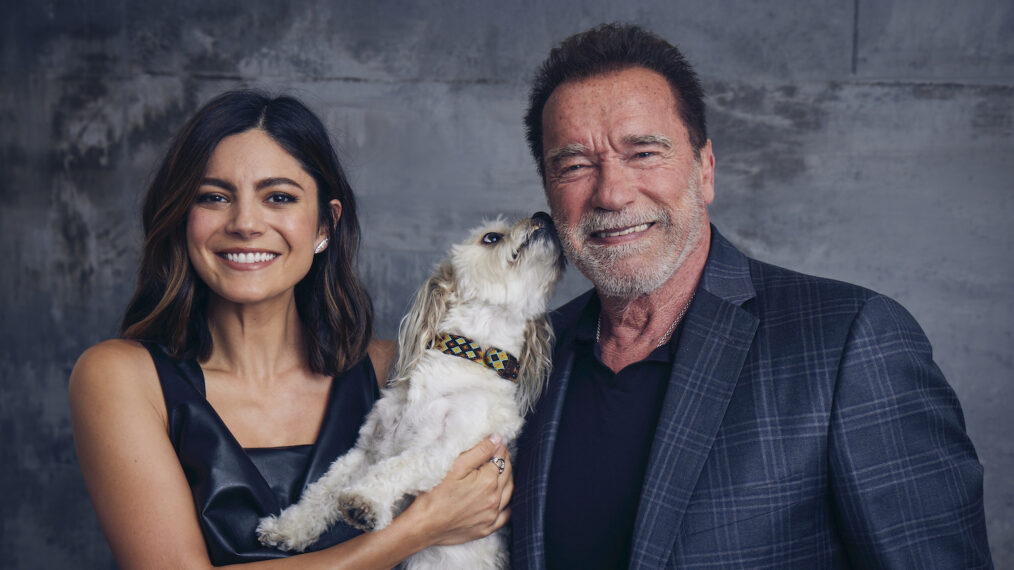 Monica Barbaro and Arnold Schwarzenegger, with Augie, at the 'FUBAR' shoot