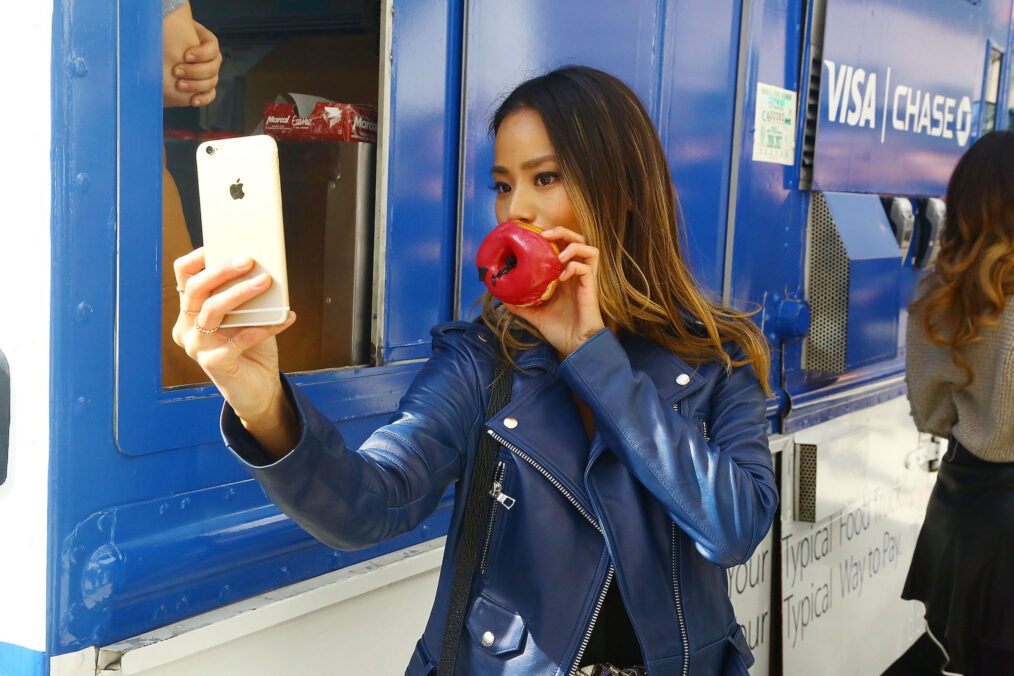 Jamie Chung eats a donut to celebrate the launch of Apple Pay in 2014