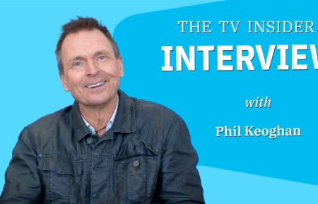 Phil Keoghan against a blue background with the text