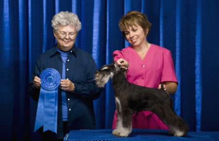 Owner, judge and dog with first place ribbon