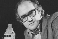 Presenter James Burke with a scale model of the set for a feature of the BBC television series 'Moonbase 3', 1973