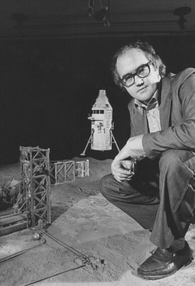 Presenter James Burke with a scale model of the set for a feature of the BBC television series 'Moonbase 3', 1973. Printed in Radio Times issue 2600, published on September 6th 1973