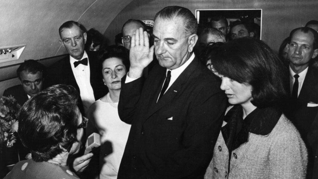 Lyndon Baines Johnson is sworn in as the 36th President of the United States of America on board the presidential airplane, after the assassination of President John F Kennedy. Mrs Johnson is behind him, left, and to his right is the grief stricken Jackie Kennedy.