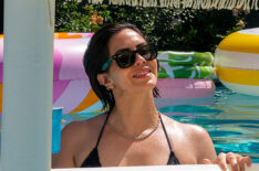 Katie Maloney swimming in a pool with a Something About Her pool float during Vanderpump Rules - Season 11