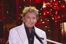 Barry Manilow sits at a piano during 'Barry Manilow's a Very Barry Christmas'