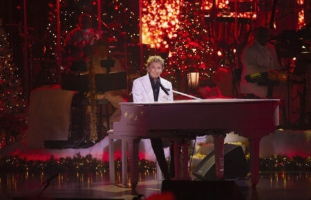 Barry Manilow sits at a piano during 'Barry Manilow's a Very Barry Christmas'