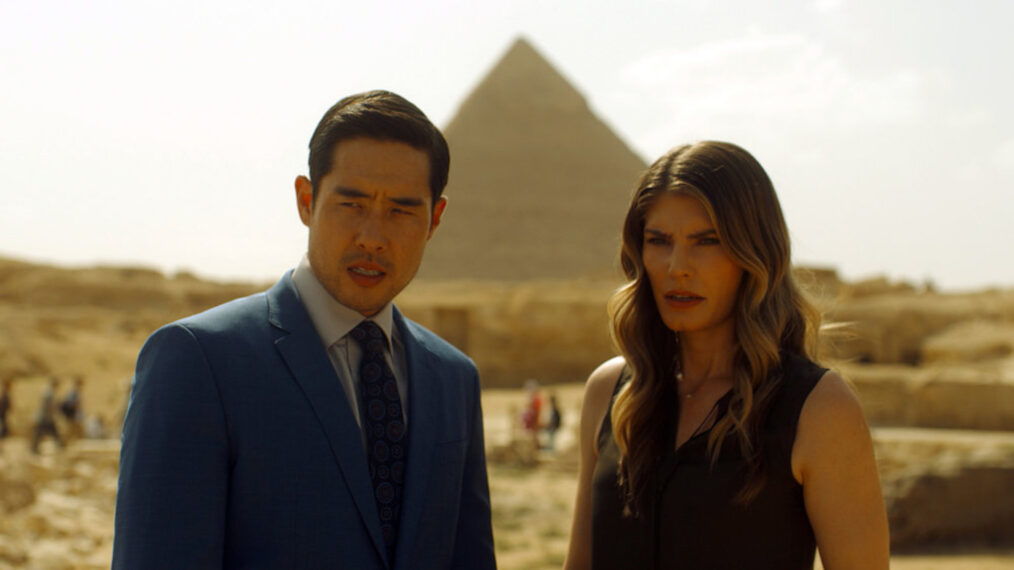 Raymond Lee as Dr. Ben Song, Caitlin Bassett as Addison in front of the pyramids in Egypt in 'Quantum Leap' - Season 2, Episode 8