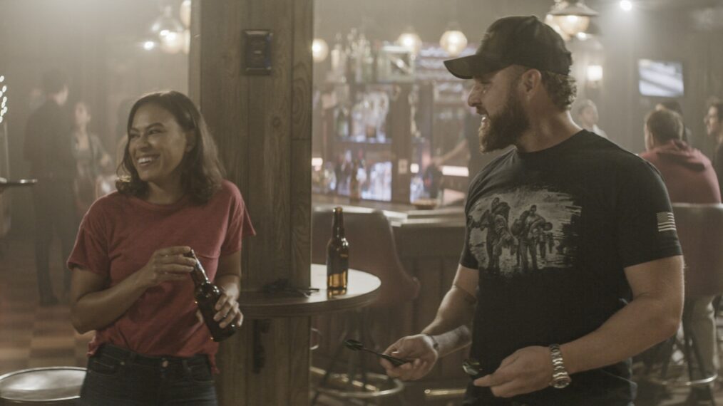 Toni Trucks as Lisa Davis and AJ Buckley as Sonny Quinn playing darts at the bar in 'SEAL Team' - 'The New Normal'