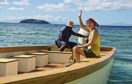Emily Flippen waves while sitting on a boat in 'Survivor' Season 45 Episode 11