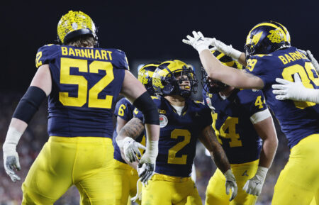 Blake Corum #2 of the Michigan Wolverines celebrates with teammates after scoring a touchdown in overtime against the Alabama Crimson Tide during the CFP Semifinal Rose Bowl Game at Rose Bowl Stadium on January 01, 2024 in Pasadena, California