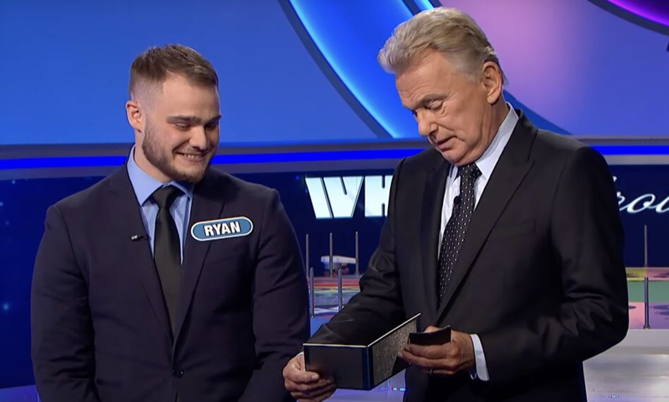 Pat Sajak and contestant on Wheel of Fortune