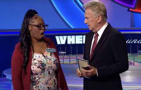 Pat Sajak and contestant on Wheel of Fortune