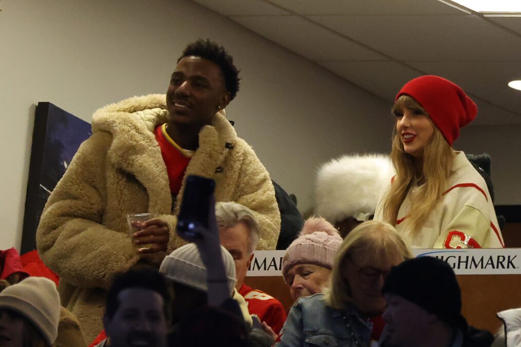 Jerrod Carmichael and Taylor Swift watch the second quarter in the AFC Divisional Playoff game between the Kansas City Chiefs and the Buffalo Bills