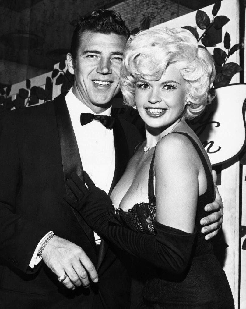Jayne Mansfield surprised even Hollywood's jaded eyes when she arrived at a recent filmtown soiree with her husband Mickey Hargitay dressed in a black silk dress with a plunging neckline that didn't stop plunging.
